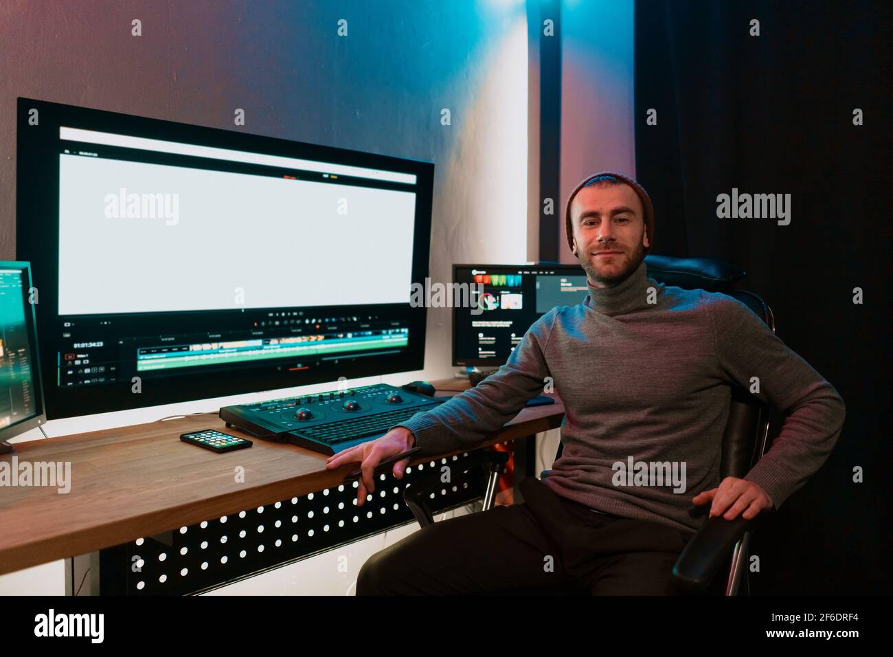 Attractive Male Video Editor Works with Footage or Video on His ...