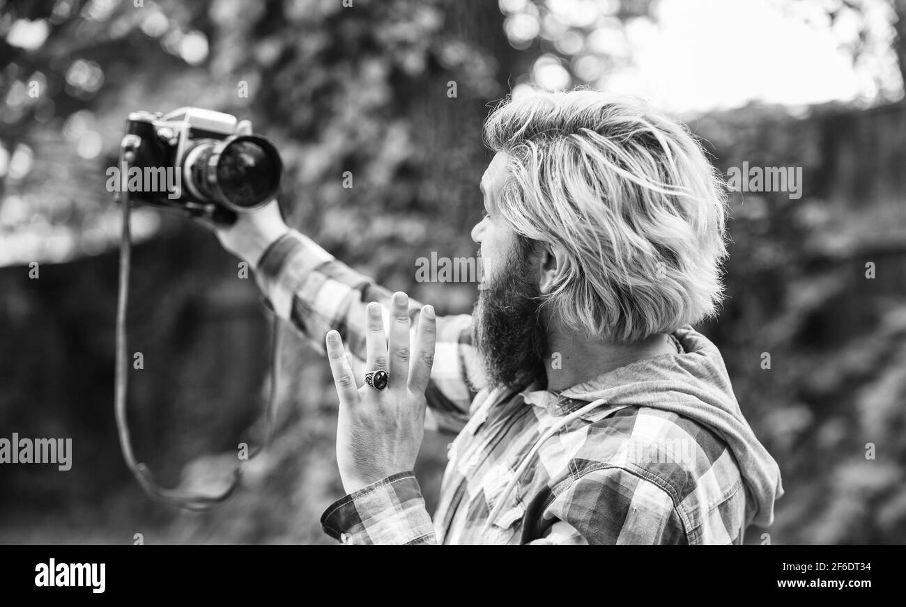capture these memories. SLR camera. hipster man with beard use professional camera. selfie time. photographer hold retro camera. journalist is my Stock Photo