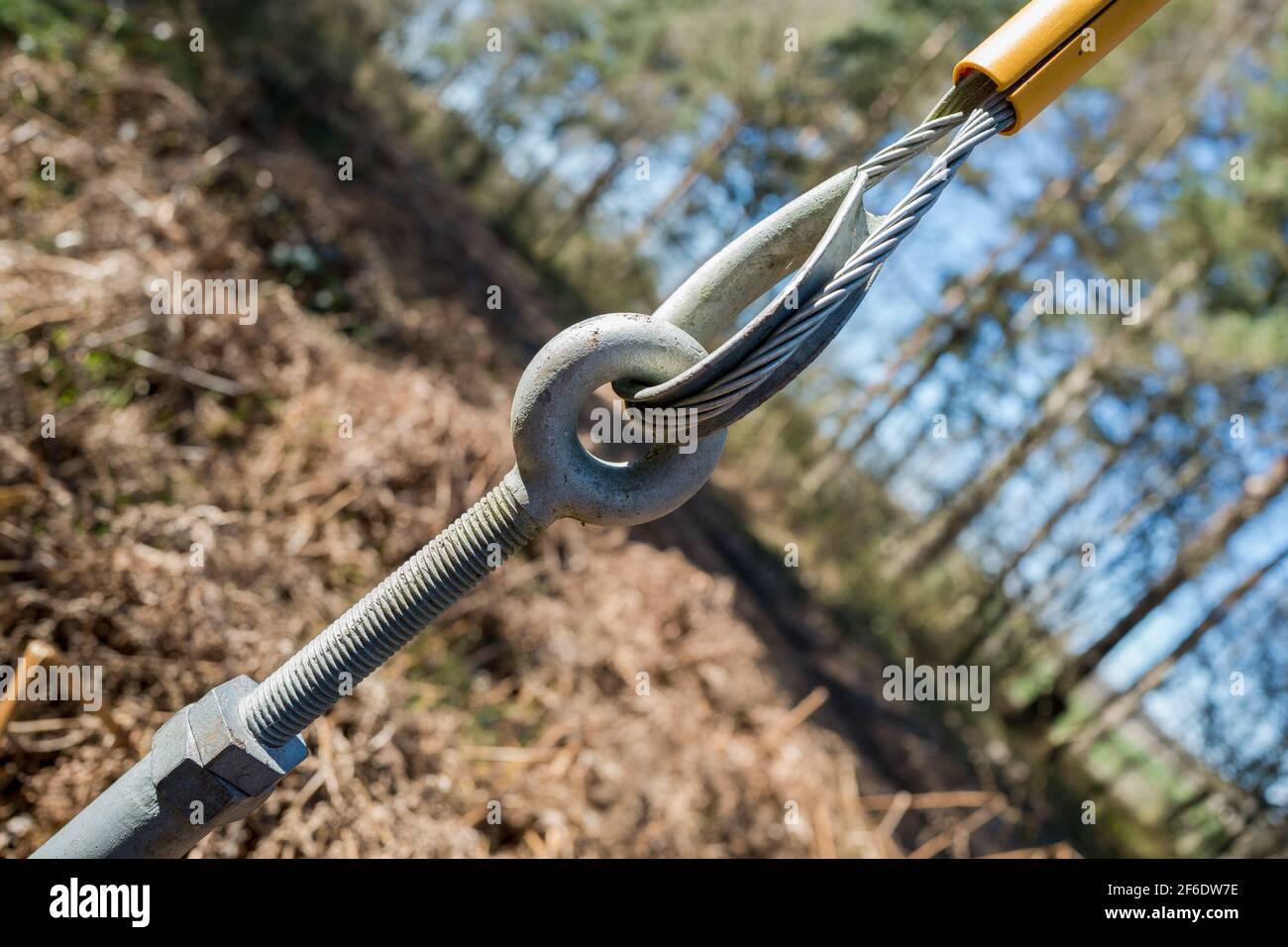 Steel galvanised turnbuckle and stranded cable supporting wooden pole