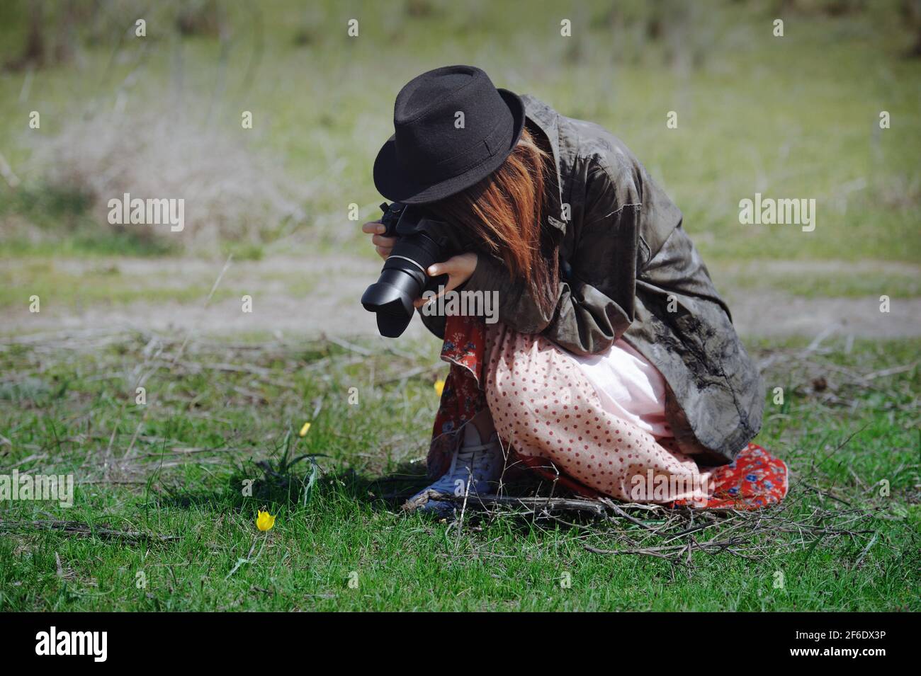 Hipster woman with digital camera taking photo of the flower Stock Photo