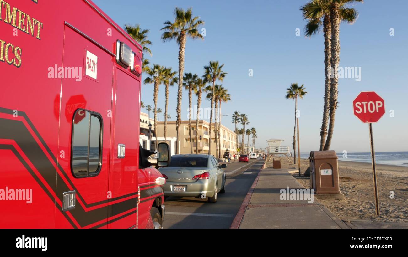 Oceanside, California USA - 11 Feb 2020: EMS emergency medical service red vehicle by ocean beach. Fire department ambulance car. Lifeguard paramedic Stock Photo