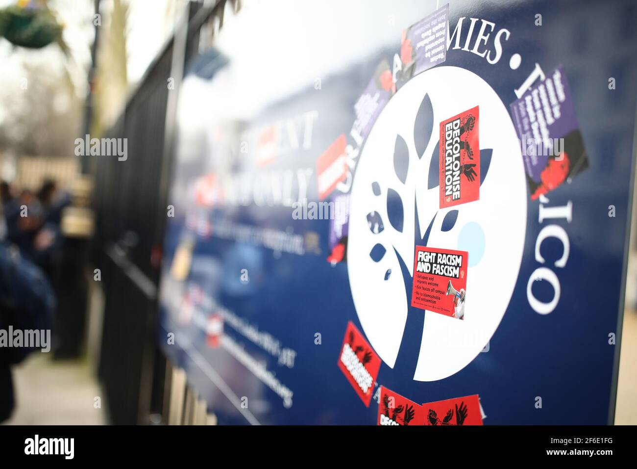 A sign covered in anti-fascism and anti-racism stickers outside Pimlico Academy School, west London, where students have staged a walkout in protest over a school uniform policy that they claim is discriminatory and racist. Picture date: Wednesday March 31, 2021. Stock Photo