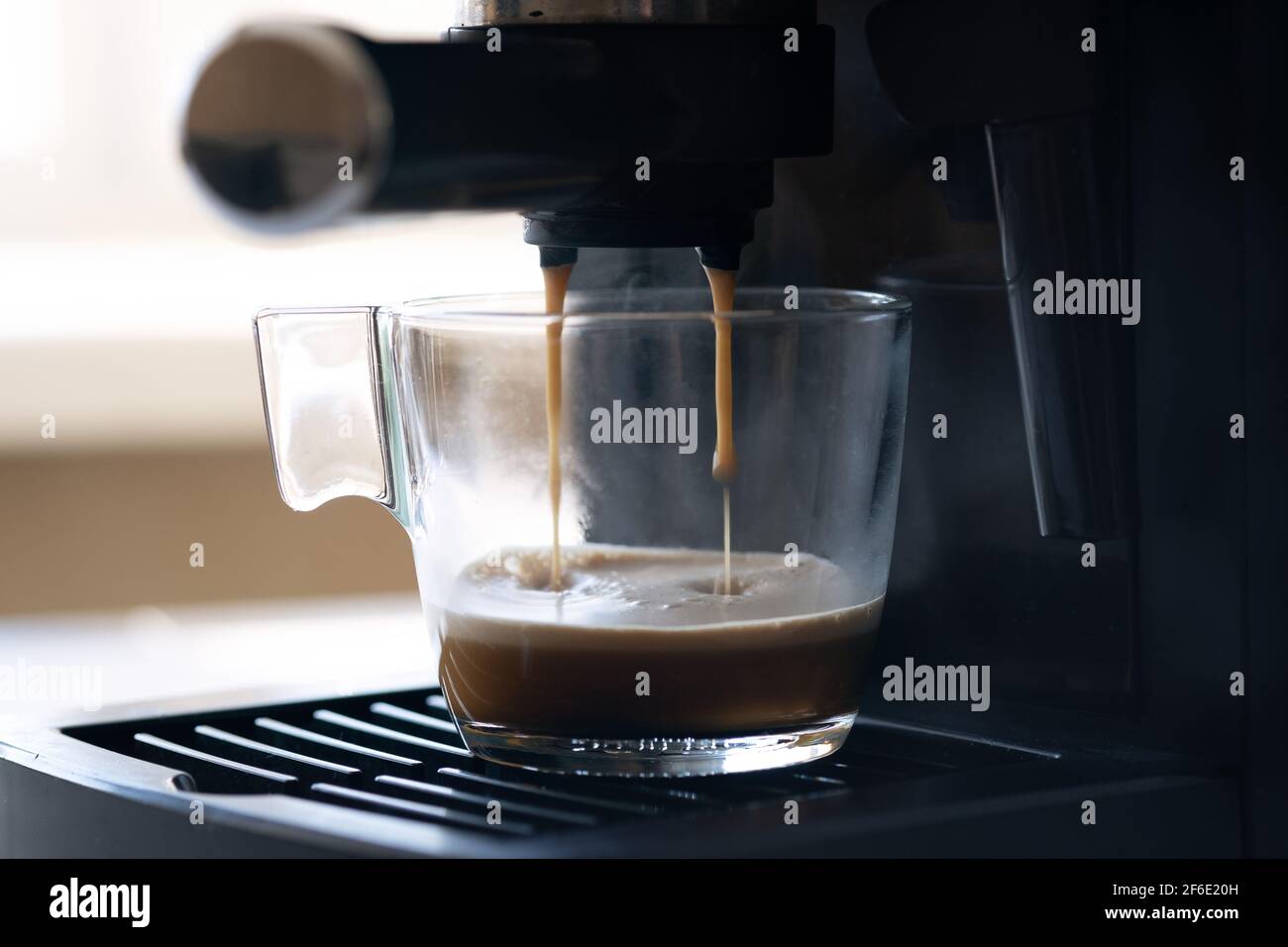 Coffee machine making espresso in glass 