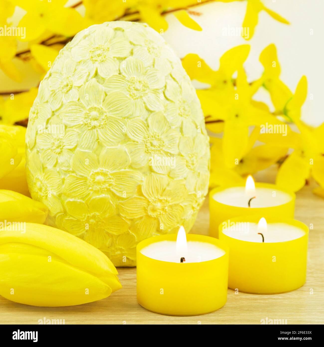 Easter decoration eggs and candles with tulips Stock Photo
