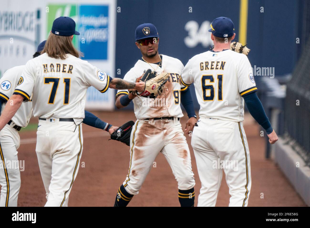 Milwaukee Brewers shortstop Freddy Zamora (94) is congratulated by  teammates during a spring training game against the Chicago White Sox,  Friday, March 26, 2021, in Phoenix, AZ. The White Sox defeated the