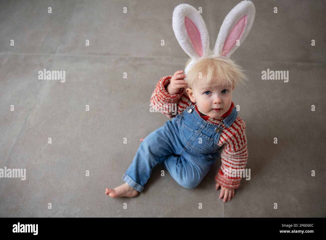 Cute little toddler boy celebrating Easter wearing easter bunny ears Stock Photo