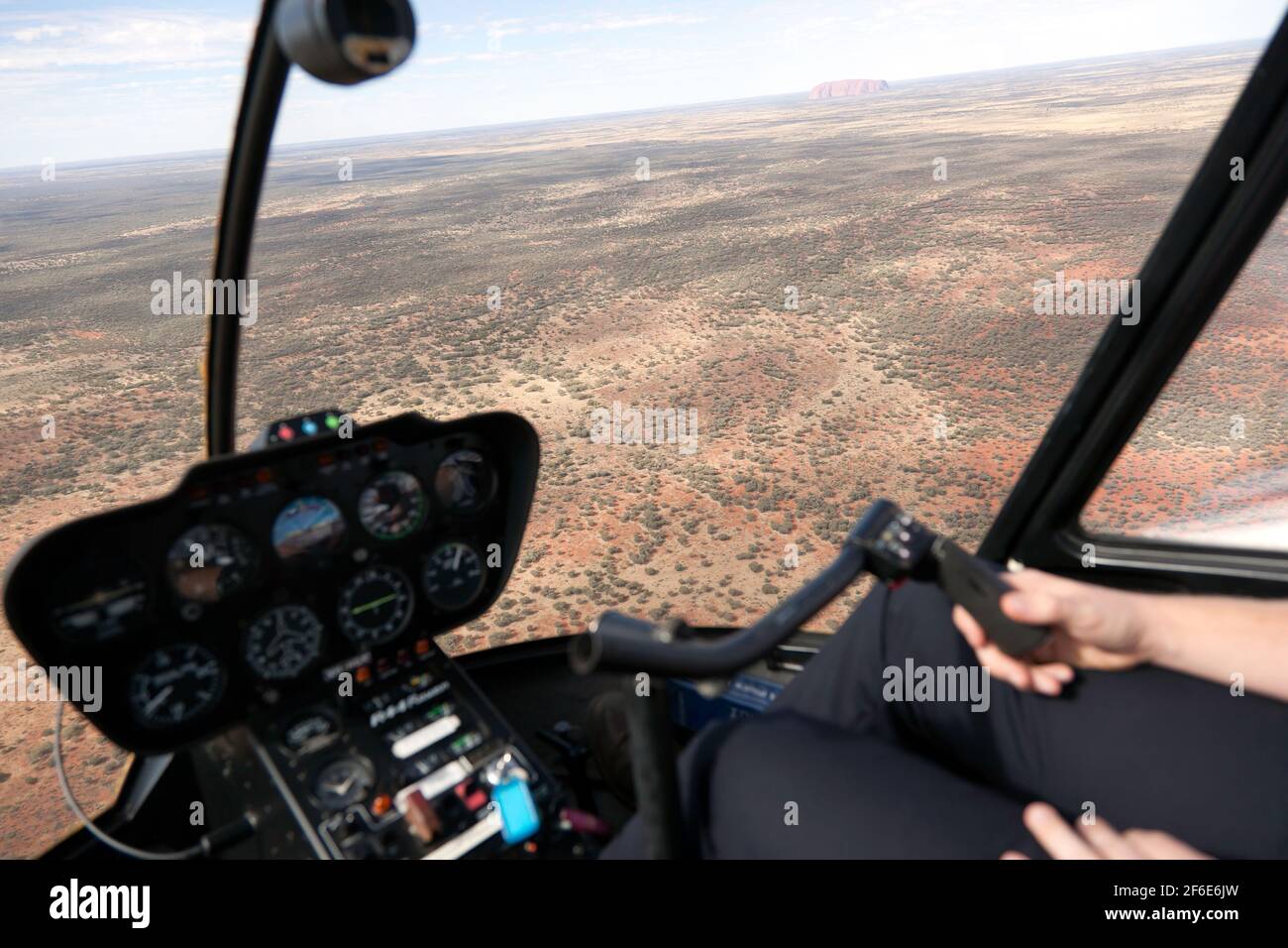 View from inside the Cockpit of an R44 Raven Helicopter, during a scenic flight over Uluṟu-Kata Tjuṯa National Park Stock Photo