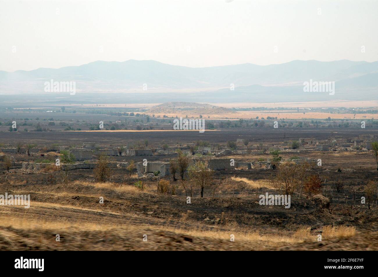 Deserted landscape with bombed houses in Nagorno Karabakh. Following the collapse of Soviet Union the war erupted between Armenia and Azerbaijan over Stock Photo