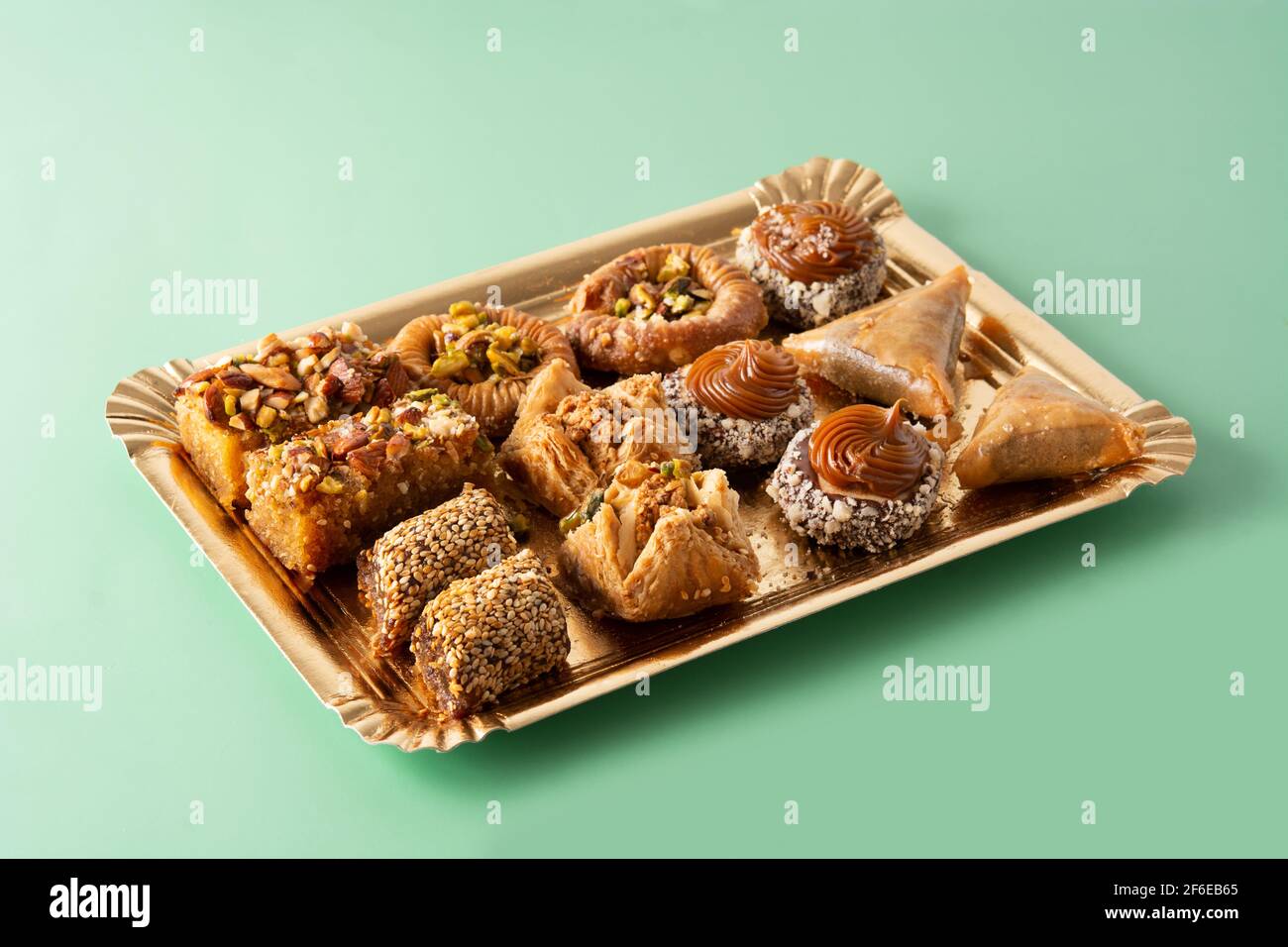 Assortment of Ramadan dessert baklava on green background Stock Photo