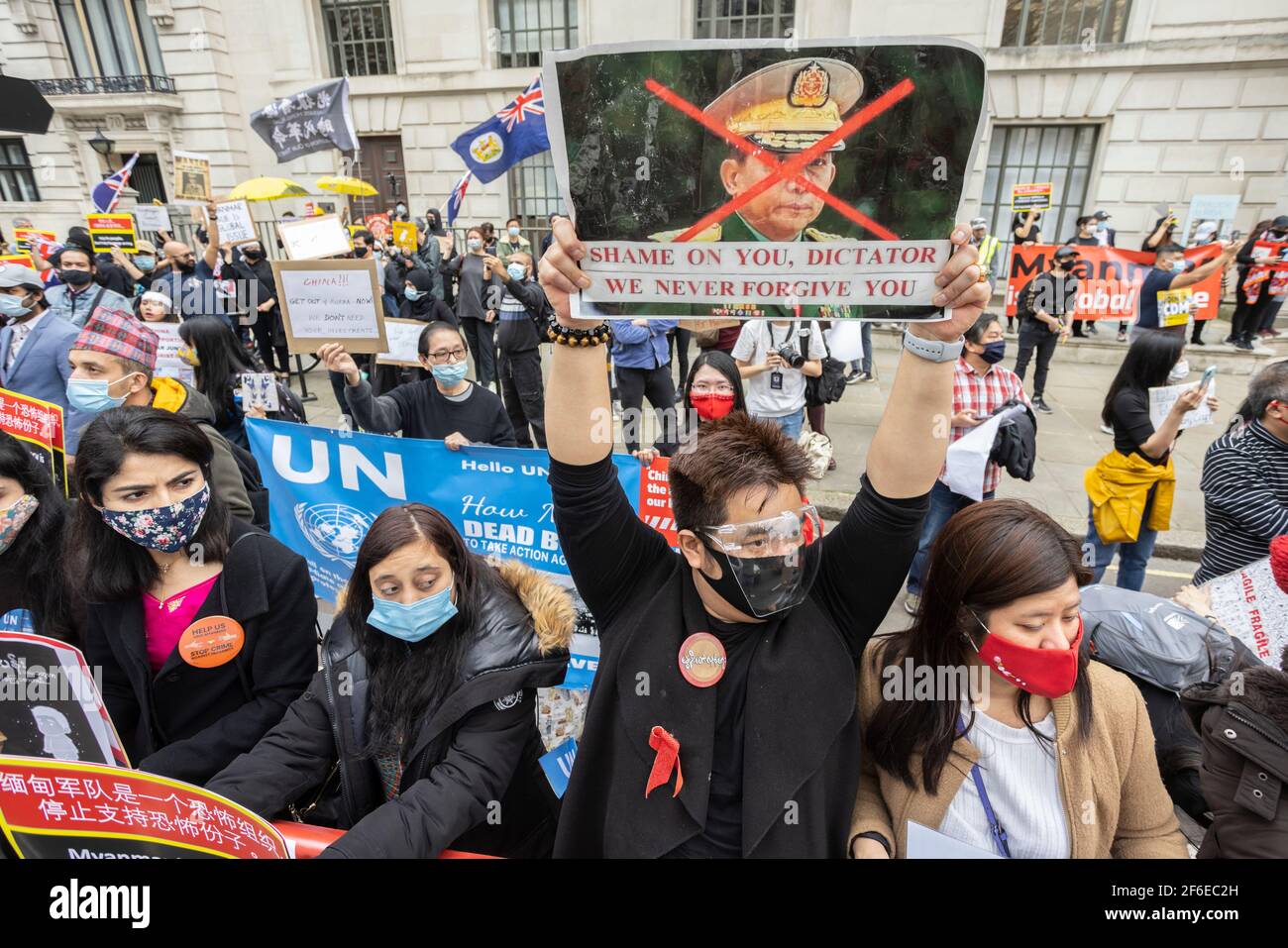 London, UK. 31st Mar, 2021. Protesters holding placards outside the Chinese Embassy. Protesters gathered in Parliament Square - wearing face masks and observing social-distancing - before marching to the Chinese Embassy in solidarity with the people of Myanmar against the military coup and state killings of civilians. Speeches were given outside the embassy. Since the beginning of the military coup on the 1st of February over 520 people have been killed in Myanmar by security forces. Last Saturday was the most violent day when more than 100 people were killed. Credit: Joshua Windsor/Alamy Live Stock Photo