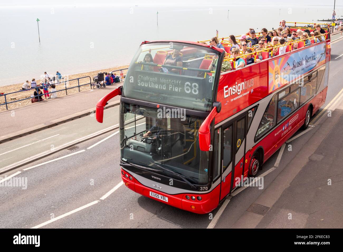 Southend on Sea, Essex, UK. 31st Mar, 2021. The last day of March has been hot and bright in Southend, but very hazy over the Thames Estuary. Ensignbus added additional buses to their seafront 'Seaside Service' open top bus service due to popular demand. Passengers enjoying the view of the seafront from the top deck Stock Photo