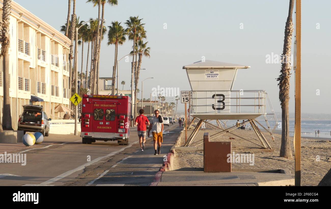 Oceanside, California USA - 11 Feb 2020: EMS emergency medical service red vehicle by ocean beach. Fire department ambulance car. Lifeguard paramedic Stock Photo