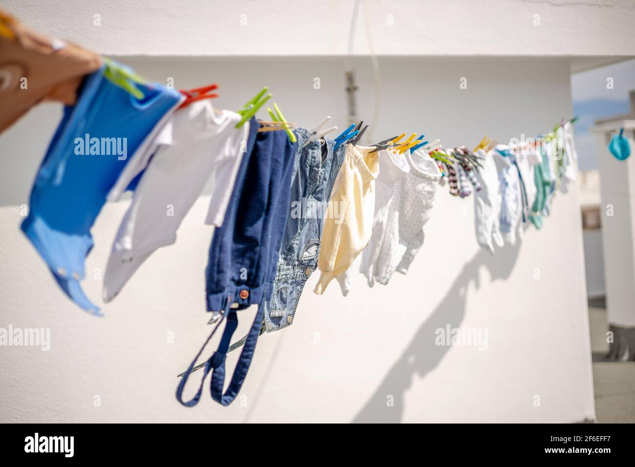 Drying a lot of baby clothes on the roof top in the city Stock Photo