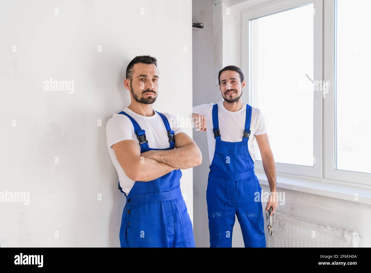 Two experienced builder in uniform posing for a photo Stock Photo