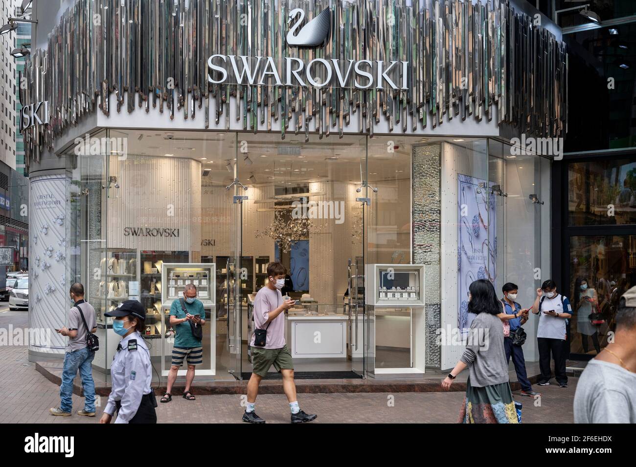 Hong Kong, China. 31st Mar, 2021. Pedestrians walks part the Austrian  jewelry producer and luxury brand Swarovski store seen in Hong Kong. (Photo  by Budrul Chukrut/SOPA Images/Sipa USA) Credit: Sipa USA/Alamy Live