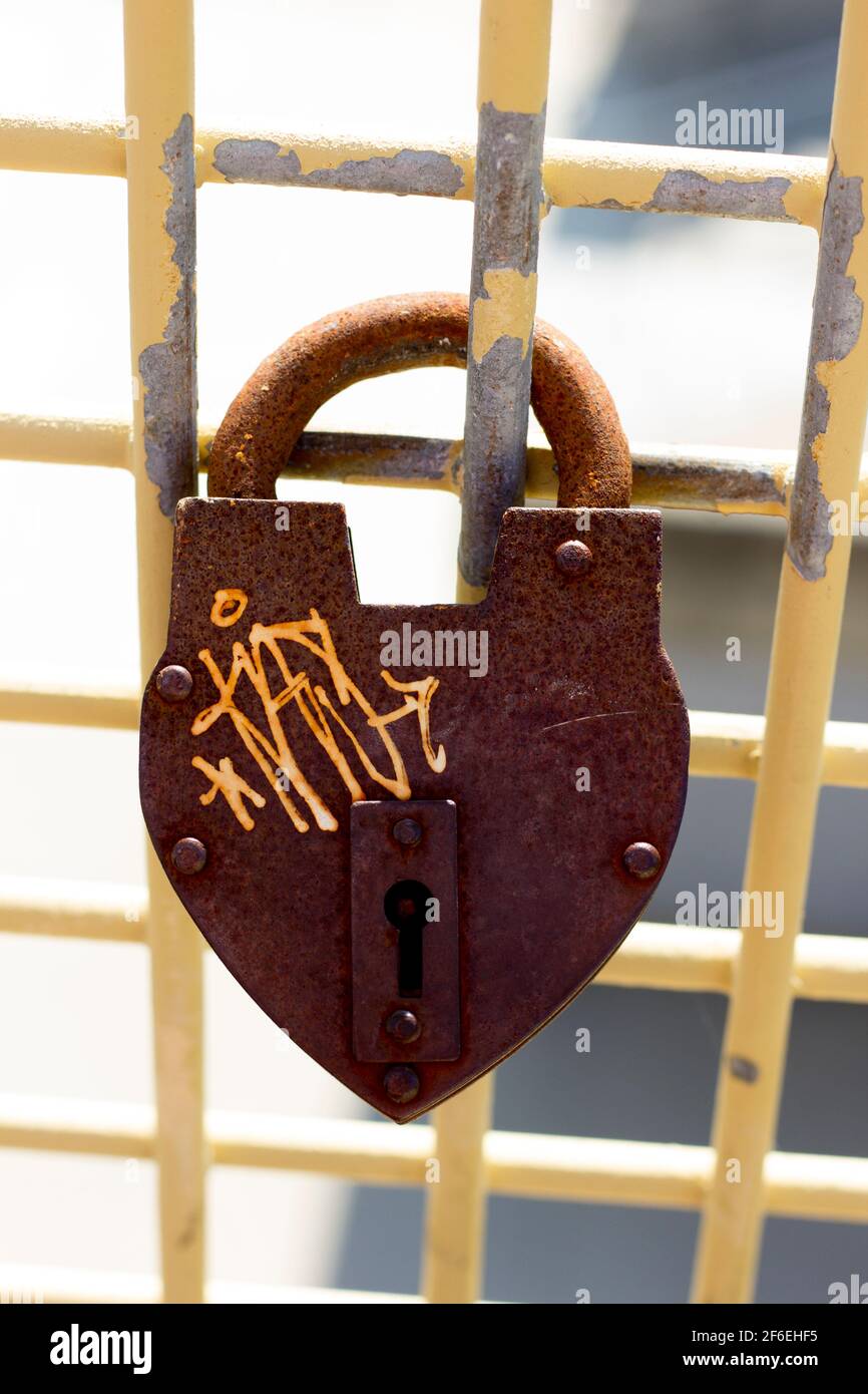 Large rusty heart shape padlock hanging on love lock wall in Pittsburgh PA Stock Photo