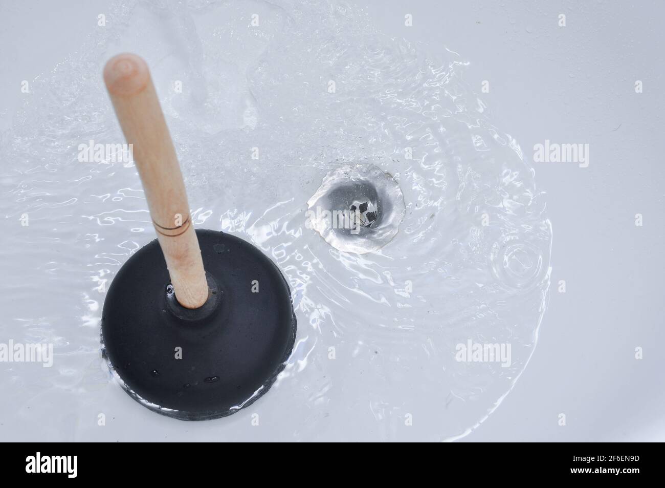 Plunger and clogged bath drain. Cleaning concept Stock Photo Alamy