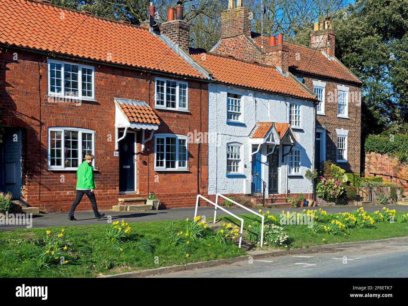 Man walking past a row of houses in the village of Walkington, East