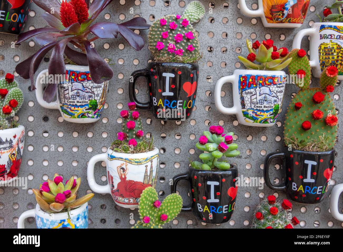 Scenes Of Popular Tourist Attractions In Barcelona Painted On China Tourist Mugs With Cactus Plants Growing In Them Barcelona Spain Stock Photo