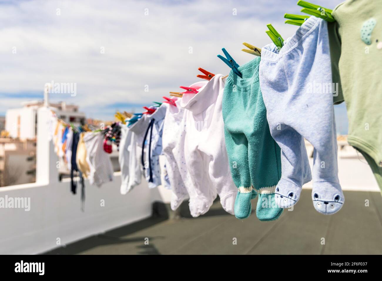 A lot of baby clothes drying on the roof in the city Stock Photo