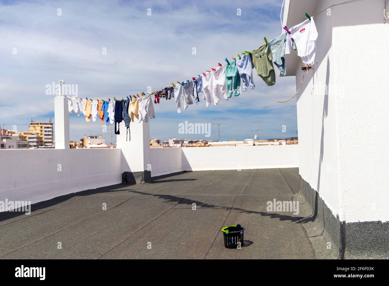 A lot of baby clothes drying on the roof in the city Stock Photo