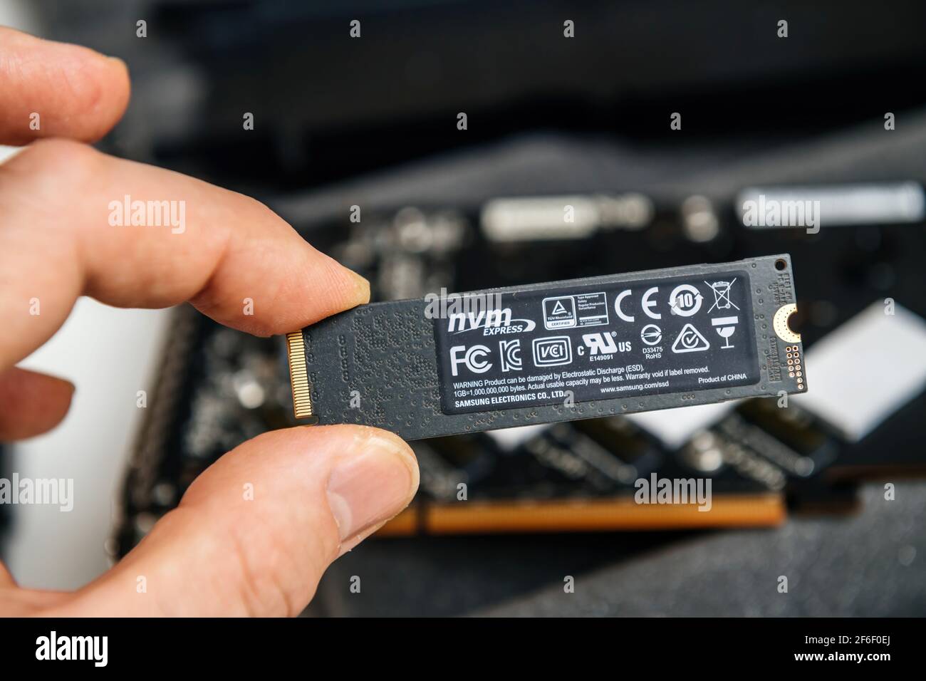 Male hand holding New NVME ssd fast computer disk near NVME raid device  pcie card with multiple certification marks and Samsung Electronics Product  of Stock Photo - Alamy