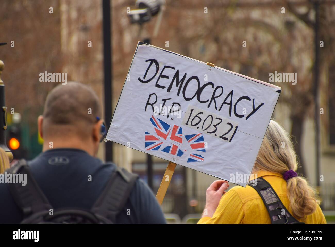 London, United Kingdom. 31st March 2021. A protester holds a placard that reads 'Democracy R.I.P. 16.03.21' in reference to the Police, Crime, Sentencing and Courts Bill. A handful of demonstrators gathered outside the parliament to protest the new police bill, government's handling of Covid, Brexit and plastic pollution. Credit: Vuk Valcic/Alamy Live News Stock Photo
