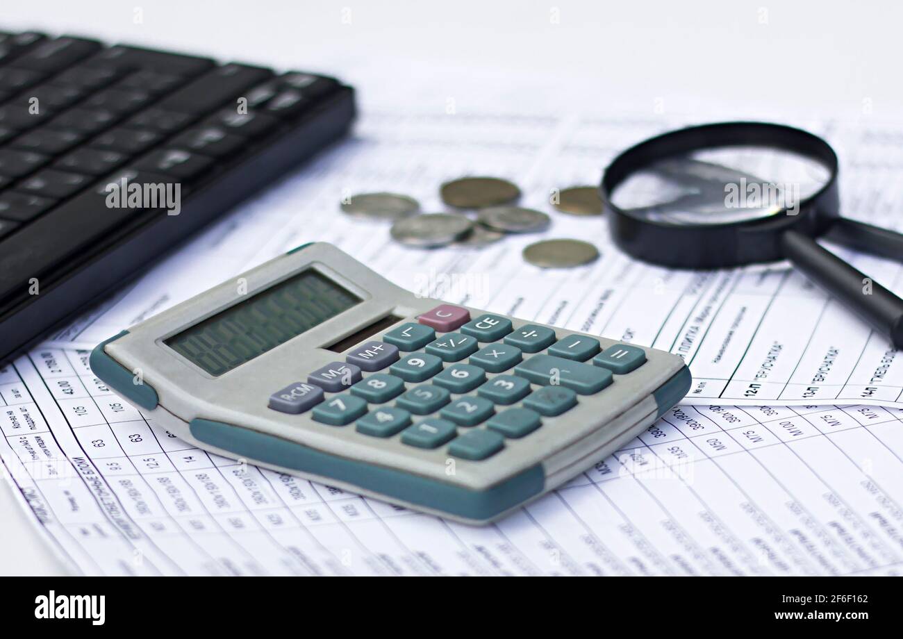 the concept of business and technology. magnifying glass, calculator, documents, securities on the office desk. Stock Photo