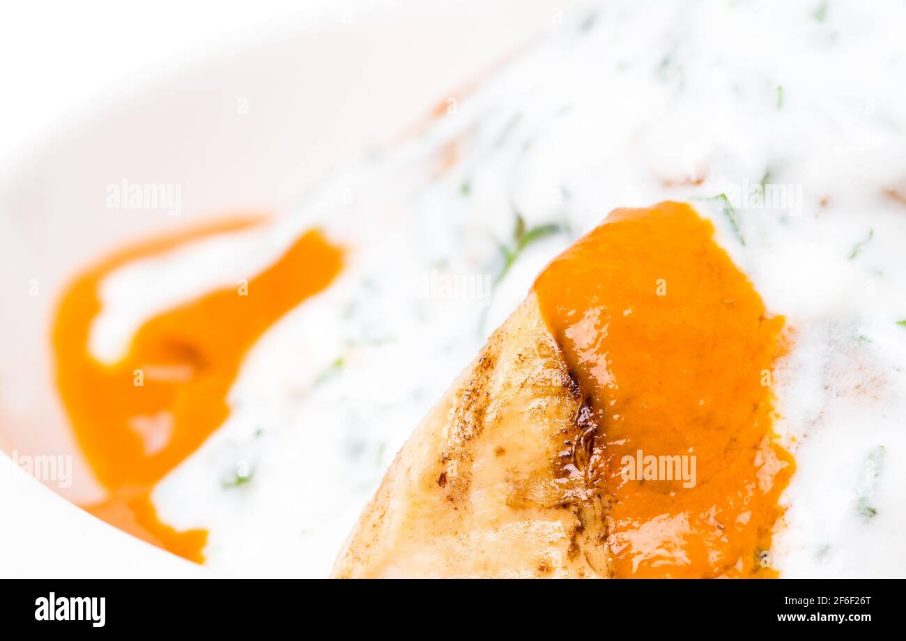 Delicious chicken tikka masala with yoghurt and minced herb. Macro. Photo can be used as a whole background. Stock Photo