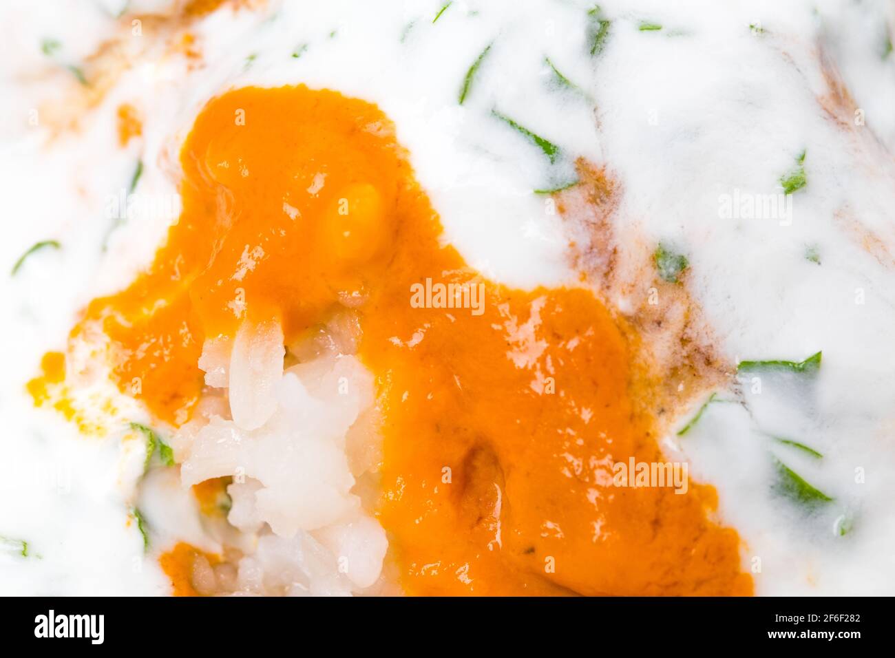 Delicious chicken tikka masala with yoghurt and minced herb. Macro. Photo can be used as a whole background. Stock Photo