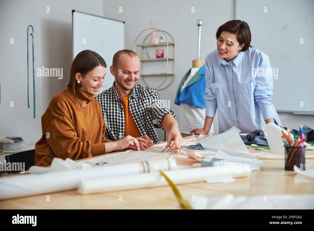Positive friendly designers looking happy to work together Stock Photo