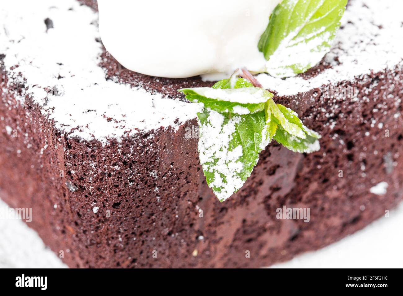 Chocolate brownie cake with vanilla ice cream on top and covered with ...