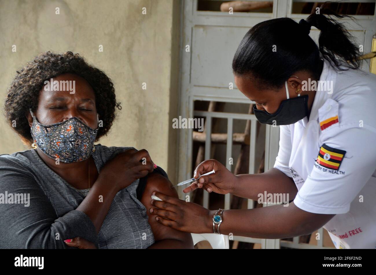 Kampala, Uganda. 31st Mar, 2021. A teacher receives a dose of COVID-19 vaccine at a health center in Kampala, capital of Uganda, March 31, 2021. Uganda launched the first phase of COVID-19 vaccination campaign on March 10, targeting high risk groups in the east African country. The ministry of health targets to vaccinate more than 21.9 million people who face the highest risk of the infection, which include health workers, teachers, security personnel, elderly and those with underlying medical conditions. Credit: Nicholas Kajoba/Xinhua/Alamy Live News Stock Photo