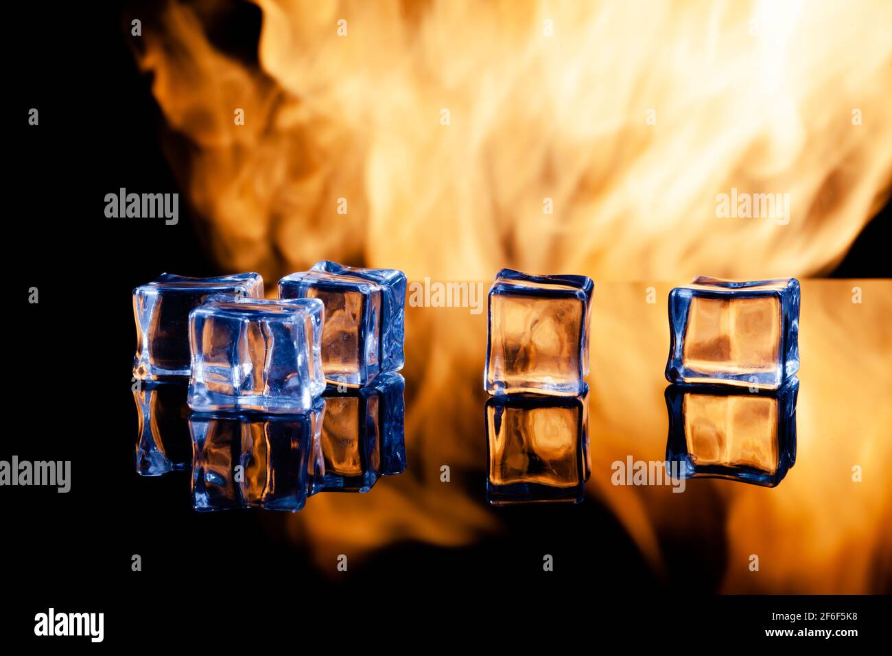 ice cubes on a black background in flames Stock Photo - Alamy