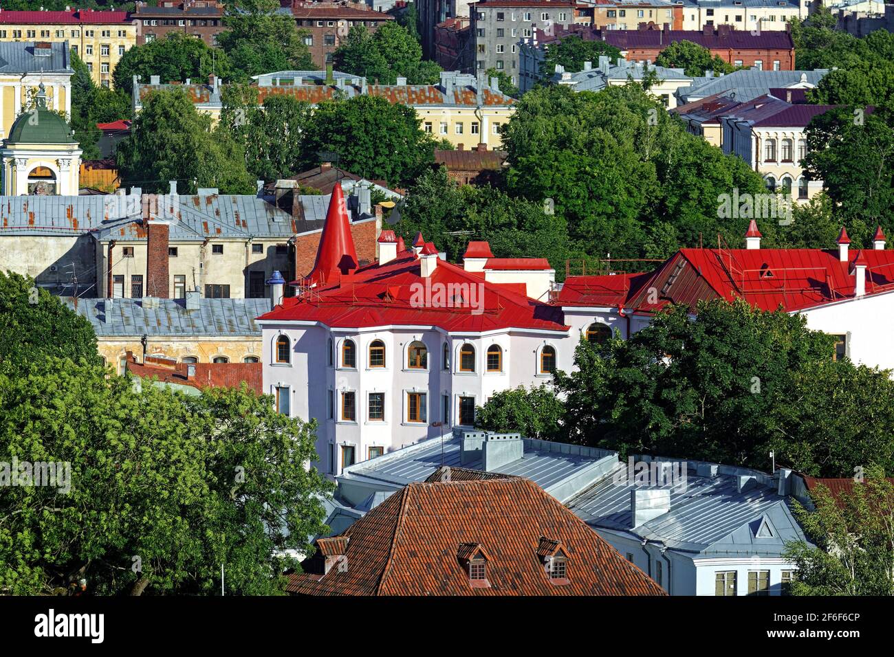 View of the colorful roofs of the old part of the city of Vyborg among the green trees. Stock Photo