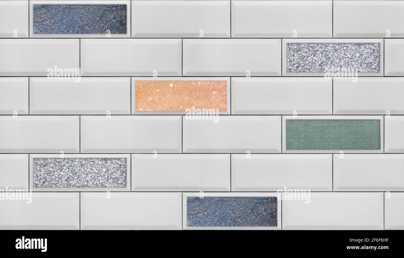 Image of a wall lined with white tiles with beveled edges and colored intersperses, for use as a seamless background. Stock Photo