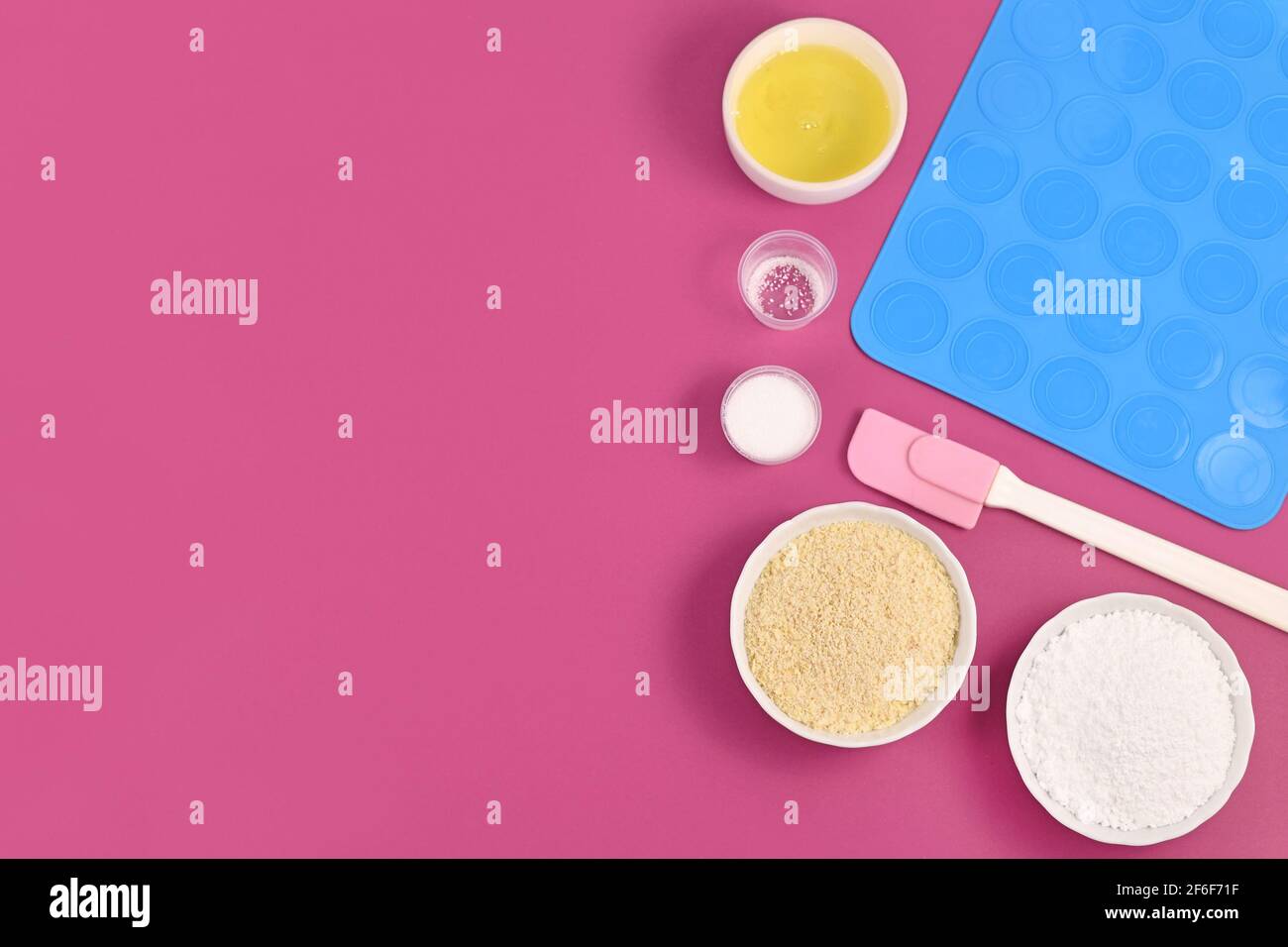 Ingredients for making homemade French Macaron sweets including powdered sugar, ground almonds, egg white, salt and baking tools Stock Photo