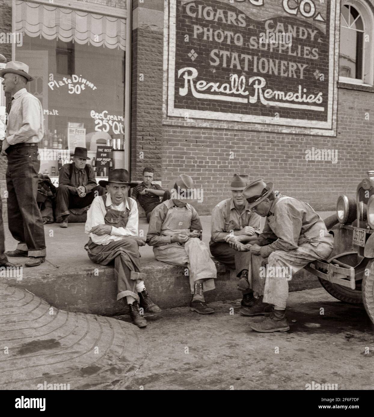Williamette Valley hop farmers in town hold their political forum on drug store corner. Independence, Oregon. 1939. Photograph by Dorothea Lange. Stock Photo