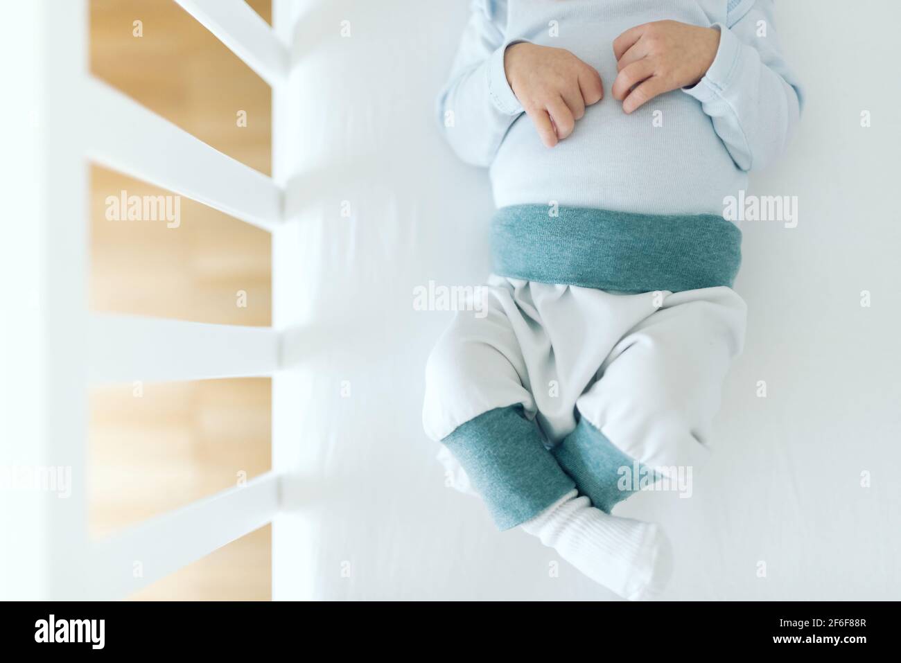 directly above view of four day old newborn baby boy in baby crib Stock Photo