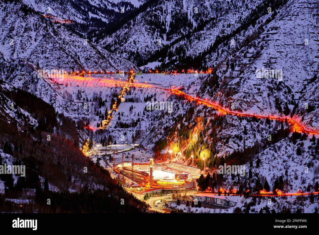 Almaty, Kazakhstan - February 19, 2021: Medeo valley with a mudflow dam and an ice skating rink of the same name at twilight Stock Photo