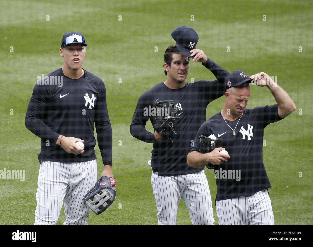 Bronx, United States. 31st Mar, 2021. New York Yankees Aaron Judge, Mike Tauchman and Brett Gardner warm up on the field one day before their 2021 MLB Opening Day game against the Toronto Blue Jays at Yankee Stadium on Wednesday March 31, 2021 in New York City. Due to the ongoing coronavirus pandemic, the attendance for the Yankees' Opening Day meeting with the Toronto Blue Jays will be around 10,000 people. Photo by John Angelillo/UPI Credit: UPI/Alamy Live News Stock Photo
