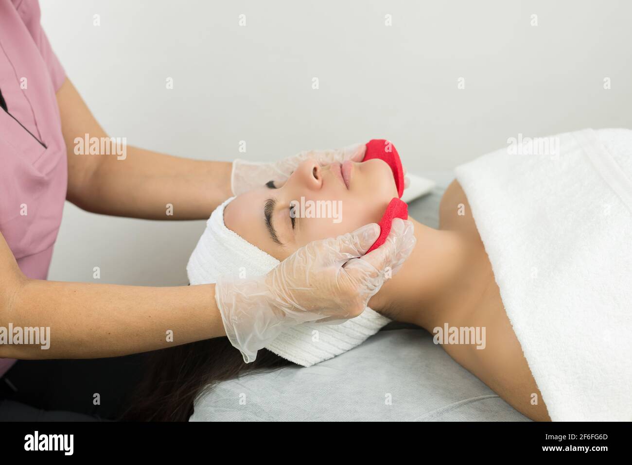 Expert cosmetologist making a deep cleansing facial Stock Photo