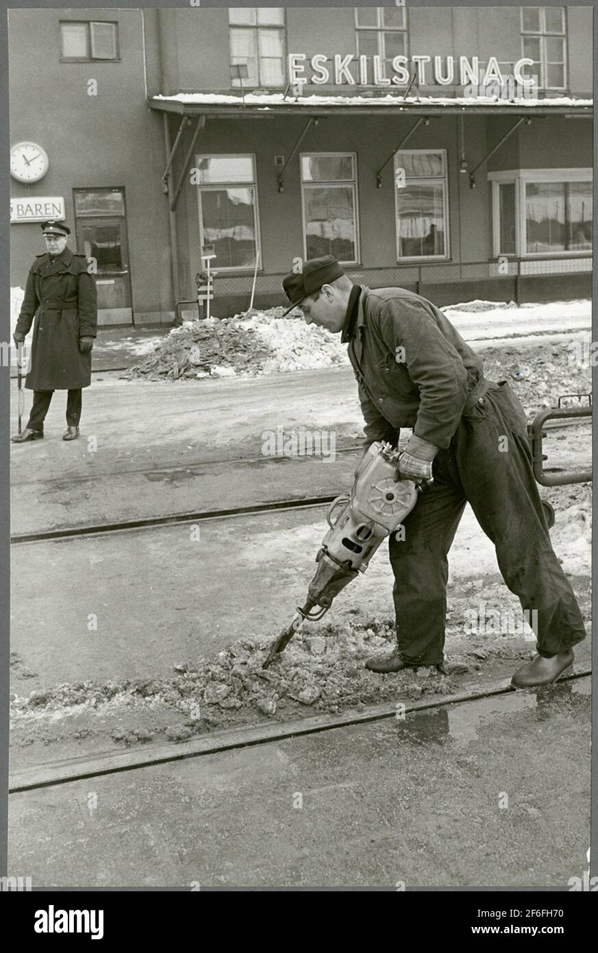 Clearing ice and snow at station Stock Photo Alamy