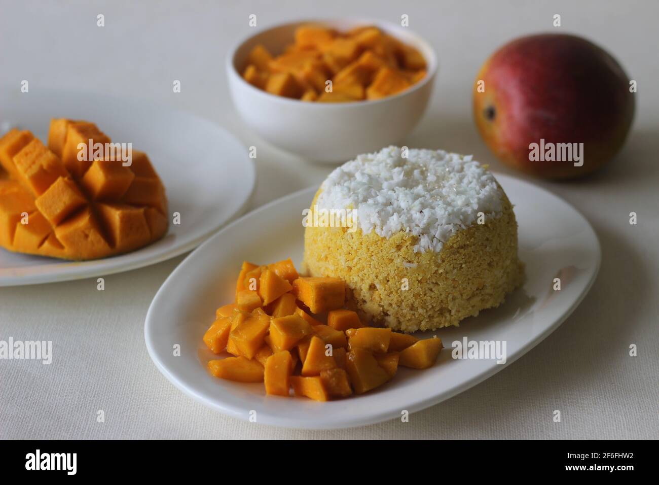 Steamed ground rice, layered with coconut shavings and mango. Locally