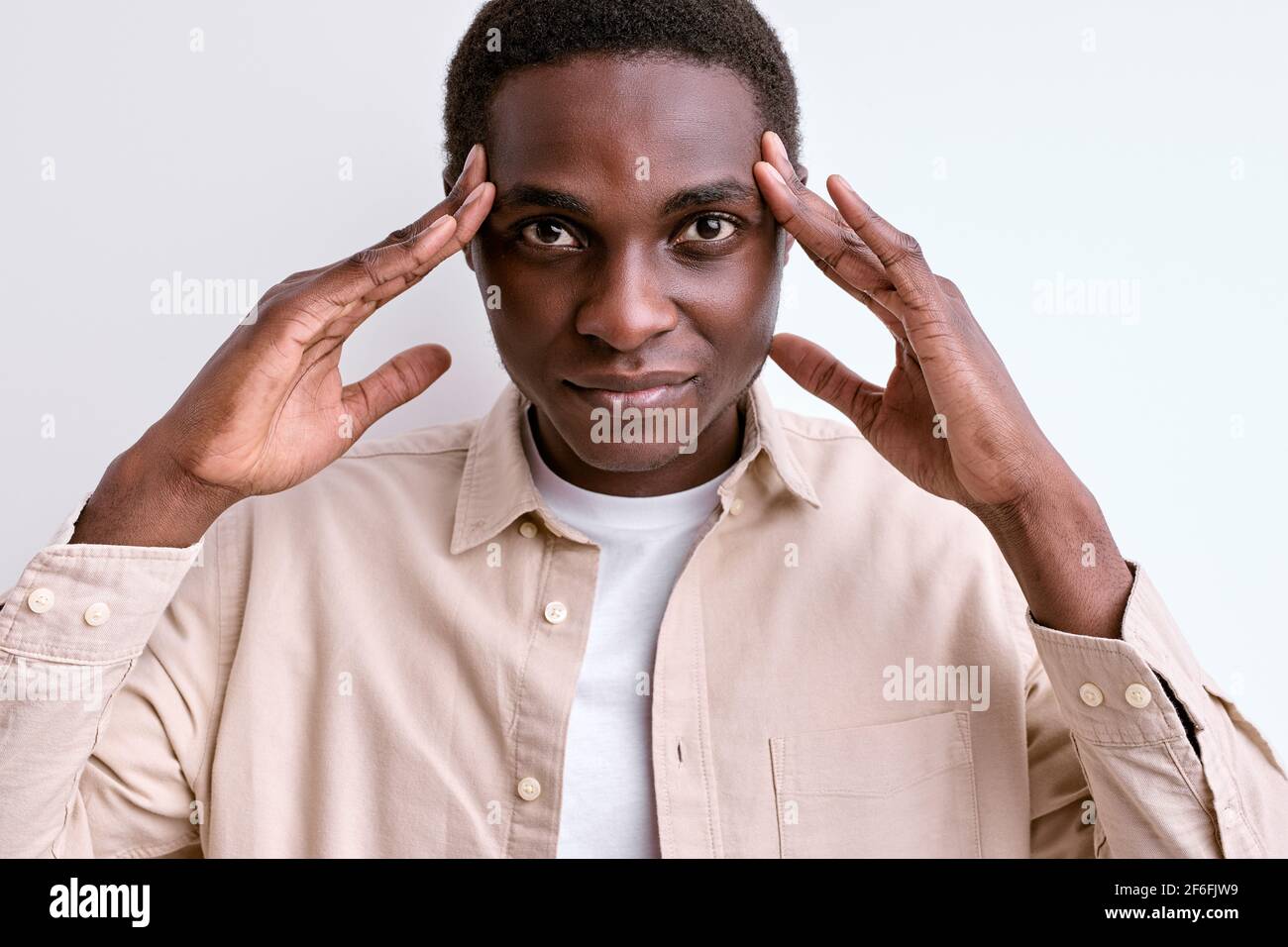 confident-black-african-man-touching-temples-stand-having-deep