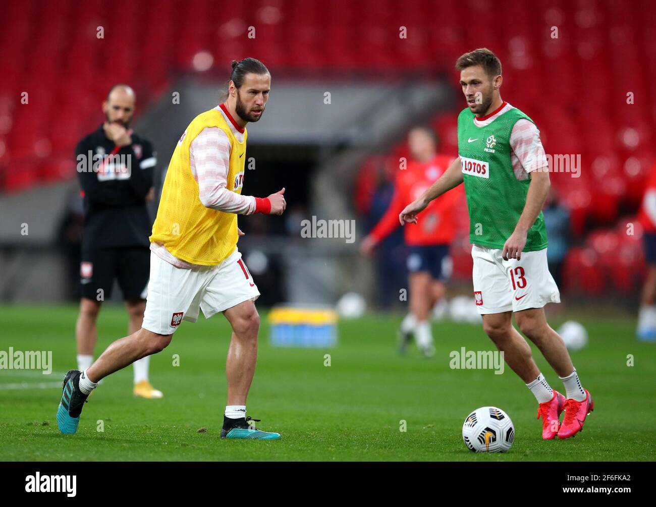 Poland's Grzegorz Krychowiak (left) and Maciej Rybus warm up prior to the 2022 FIFA World Cup Qualifying match at Wembley Stadium, London. Picture date: Wednesday March 31, 2021. Stock Photo
