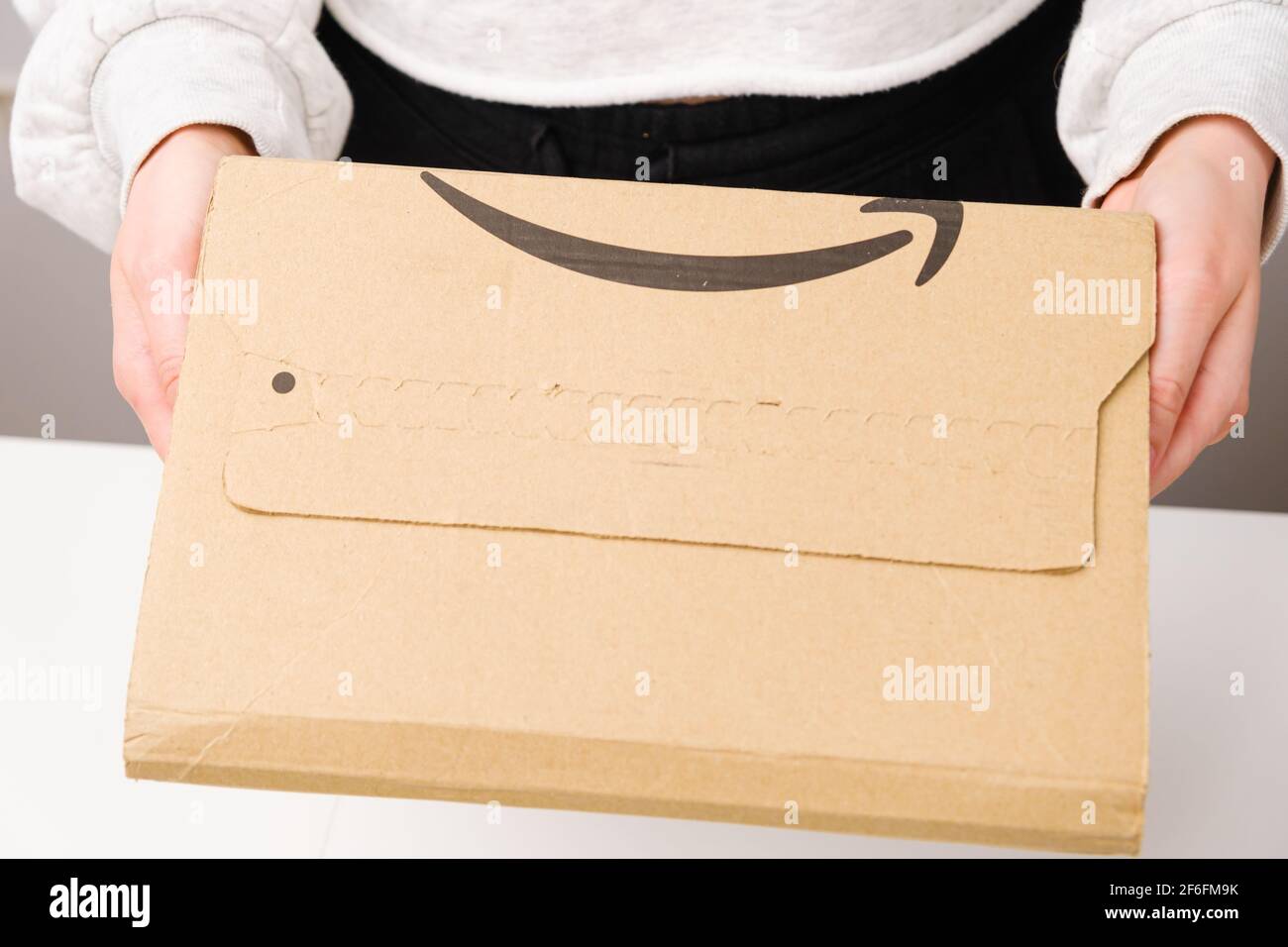 Woman holding a parcel from Amazon, March 2021, Prague, Czech Republic
