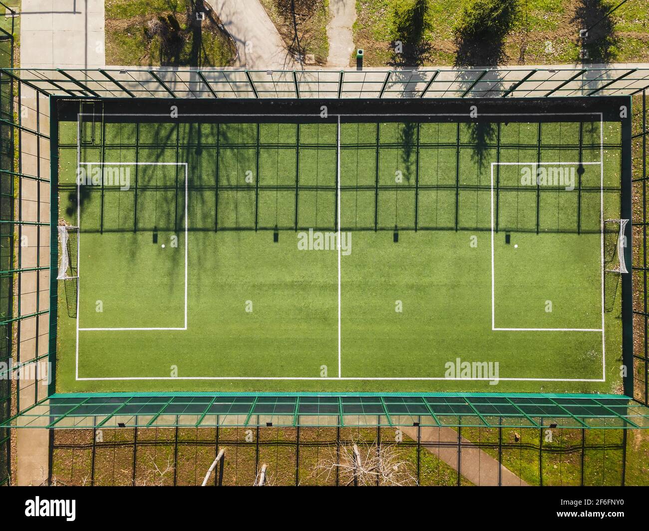 Drone View Of Street Soccer Court. Outdoor sport ground with green surface for playing football  or soccer  in urban area, detail, drone view Stock Photo