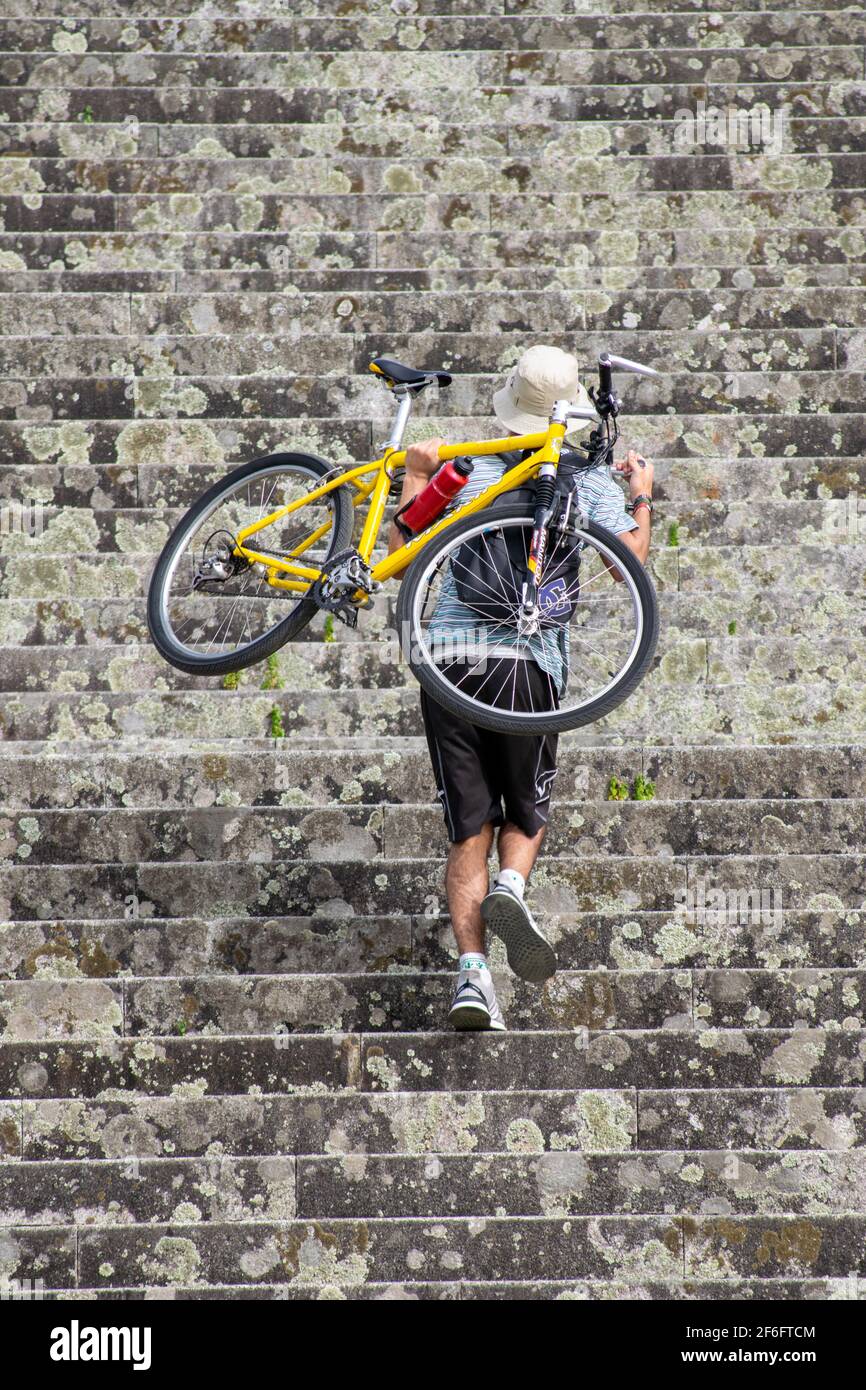 Young man carrying his bicycle on his back or shoulders while climbing  stairs for short cutting in Sameiro Sanctuary in Braga, Portugal Stock  Photo - Alamy