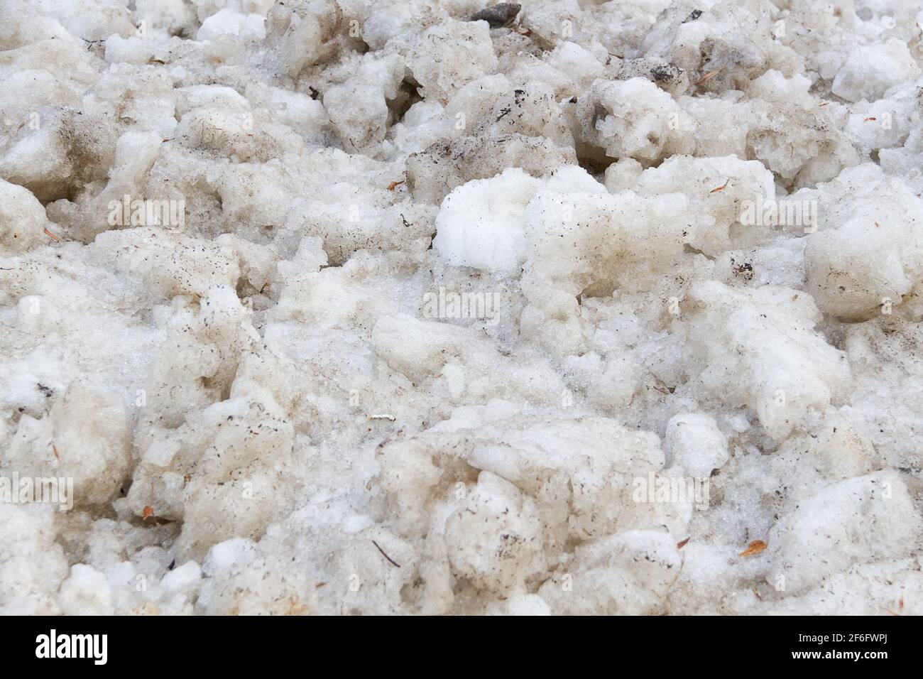 Early spring time dirty gray melted snow with sand pattern texture Stock Photo